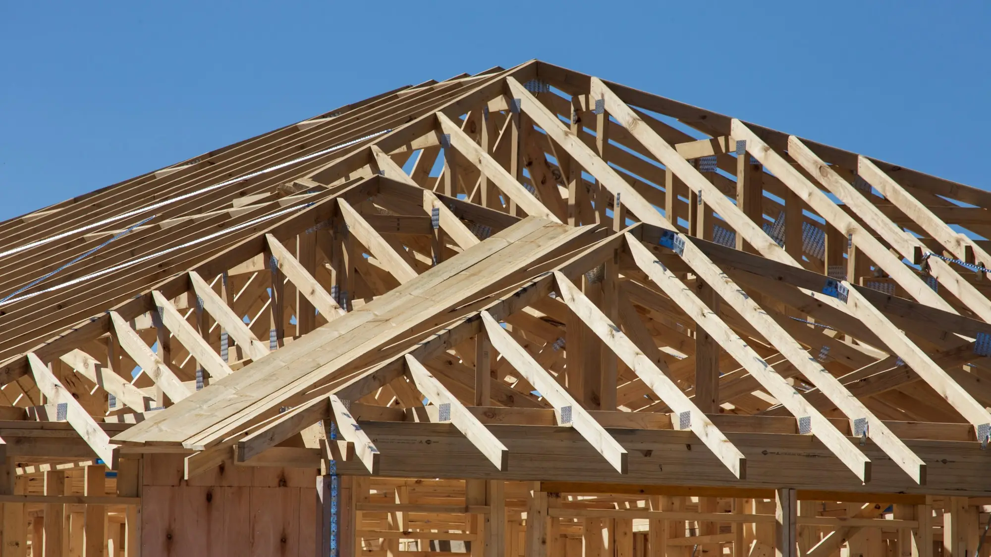 Roof framing going up on a new home (placeholder photo)